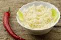 White plate of cooked long-grain rice on wooden background. Healthy eating, diet Royalty Free Stock Photo