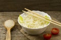 White plate of cooked long-grain rice on wooden background. Healthy eating Royalty Free Stock Photo