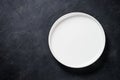 White plate, cutlery and napkin on black table top view. Royalty Free Stock Photo