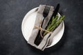 White plate, cutlery and napkin on black table top view. Royalty Free Stock Photo