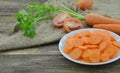 Cuts slices of carrot in plate on wooden Royalty Free Stock Photo