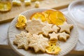 White plate with delicious fresh pastries. cookies in the form of stars and an orange on the table. hand made