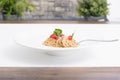 White plate of delicious-looking spaghetti with tomato and basil Royalty Free Stock Photo