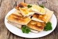 White plate with envelopes of thin Armenian bread lavash fried