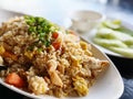 Fried rice with pork and vegetable in white plate on black background Royalty Free Stock Photo