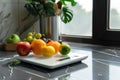 A white plate filled with fresh fruit sitting on a kitchen counter Royalty Free Stock Photo