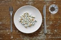 White plate filled with variety of pills Royalty Free Stock Photo