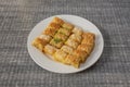 White plate filled with various flavors arabic baklava