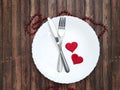 White plate, fork, knife, heart wooden background Royalty Free Stock Photo