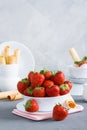 Plate with fresh strawberry and wafer tubules grey concrete back Royalty Free Stock Photo