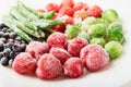 White plate with frozen food in a plate - strawberries with shadberry and brussels sprouts with asparagus beans Royalty Free Stock Photo