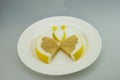 White plate, grapefruit slices, the butterfly shape Royalty Free Stock Photo