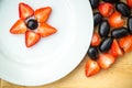 White plate with grapes and strawberries,star form Royalty Free Stock Photo