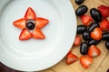 White plate with grapes and strawberries, star form Royalty Free Stock Photo