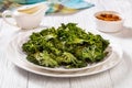 White plate with kale chips on the table Royalty Free Stock Photo