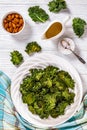 White plate with kale chips on the table Royalty Free Stock Photo