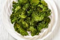 White plate with kale chips on the table Royalty Free Stock Photo