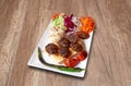 Kefta and vegetables on wooden table