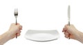 White plate, knife and fork cutlery in hands Royalty Free Stock Photo