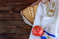 White plate with matzah or matza and Passover Haggadah on a vintage wood