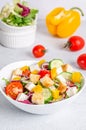 White plate with mix vegetable salad, greens, crackers and sesame seeds on a light background Royalty Free Stock Photo