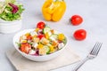 White plate with mix vegetable salad, greens, crackers and sesame seeds on a light background Royalty Free Stock Photo