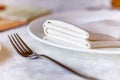White plate with napkin and silver fork Royalty Free Stock Photo