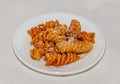 White plate with pasta spaghetti with red tomato sauce,  arrabiata with mushrooms, bacon, parmezan Royalty Free Stock Photo