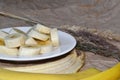 on a white plate, pieces of banana and field spikes Royalty Free Stock Photo