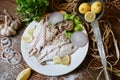 White Plate With Fish and Lemons on Top Royalty Free Stock Photo