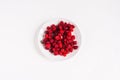 White plate with raspberries. Fresh raspberries isolated on white background Royalty Free Stock Photo