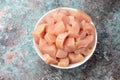 White Plate with raw chicken fillet chunks sliced into pieces on white stone Royalty Free Stock Photo