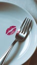 White Plate with Red Lip Print on Fork in Minimalistic Dining Scene Royalty Free Stock Photo