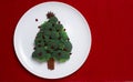 White plate on red table, broccoli tree, Christmas background, horizonta, no people,