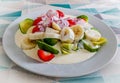 White plate serving of healthy Bananna, Strawberries, Avocado with Cream sitting on table Royalty Free Stock Photo