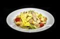 A white plate setup showing a plate of the evergreen and famous dish- The Chicken Caesar Salad Royalty Free Stock Photo