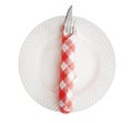 White plate with a silver fork and knife wrap red plaid napkin paper top view isolated on white background, path Royalty Free Stock Photo