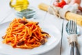 White plate with spaghetti on a table with foods of the typical food of the diet
