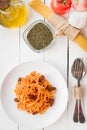 White plate with spaghetti on a table with foods of the typical food of the diet