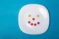 White plate with sweets on a blue background Royalty Free Stock Photo