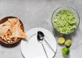 White plate with tablespoons, chips and salad from fresh cabbage with greens