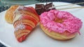 a white plate topped with donuts and pastries