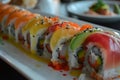 A white plate topped with sushi rolls covered in sauce, A plate of colorful sushi rolls arranged tastefully