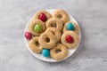 White plate with traditional Greek Easter cookies Koulourakya or Koulourya shortbread rings with sesame seeds, decorated with