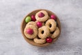 White plate with traditional Greek Easter cookies Koulourakya or Koulourya shortbread rings with sesame seeds, decorated