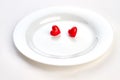 White plate with two red hearts. Royalty Free Stock Photo