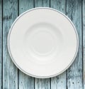 White plate on wooden background