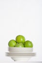 White plates and green apples Royalty Free Stock Photo