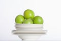 White plates and green apples Royalty Free Stock Photo
