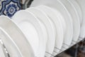 White plates on a metal stand. Clean dishes in your home kitchen. Close-up Royalty Free Stock Photo